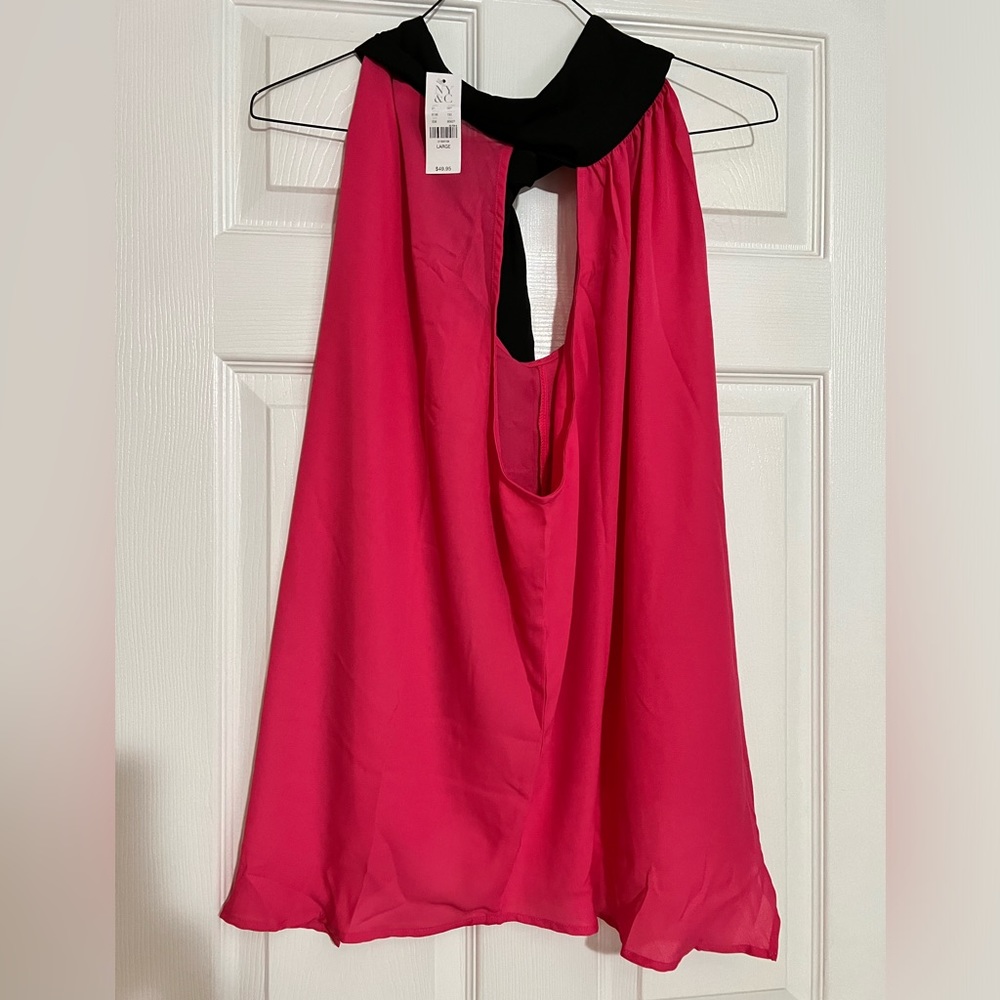 Fushia lengthy top drop down with a black halter setting in the back.